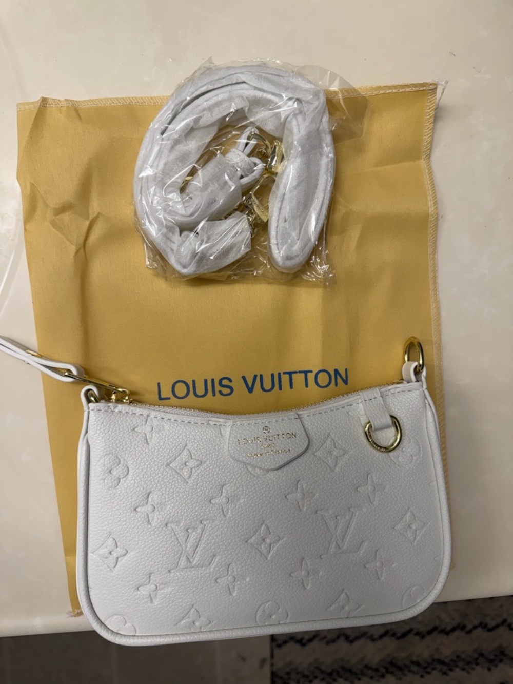 Louis Vuitton White Empreinte Mini Pochette with Gold Hardware